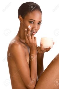 nude pictures of young ladies mocker beautiful nude young african american woman slicked back hair applying moisturizer face stock photo