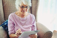 old mature women pictures warrengoldswain mature woman concentrating digital tablet stock photo only old women