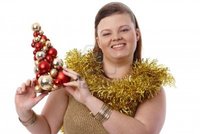 plump woman pics nyul christmas portrait happy plump woman holding small tree smiling photo