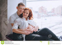 pregnant naked women pictures young pregnant woman red hair sits windowsill hugs husband was hugging naked belly women photos
