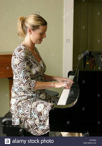 solo girl comp young blonde woman girl person playing solo piano keyboard music stock photo